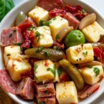 Delicious marinated cheese with salami and pickles served on a platter