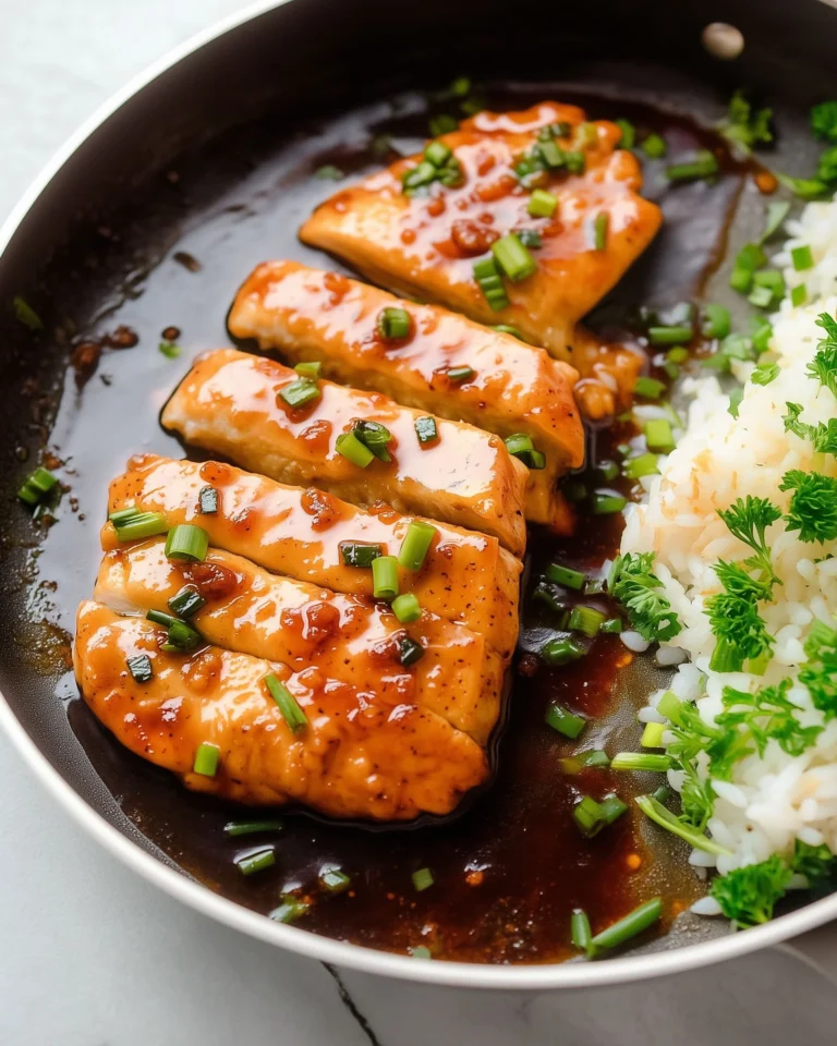 A delicious plate of Honey Garlic Chicken garnished with green onions.