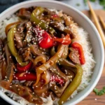 Slow cooker pepper steak served with bell peppers and sauce