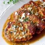 Southern Fried Pork Chops served with creamy gravy on a rustic plate