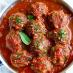 Bobby Flay's Italian meatball recipe with herbs and spices served in marinara sauce