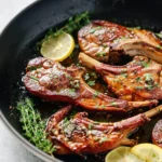 Garlic and herb crusted lamb chops served on a plate