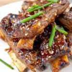 Grilled Korean BBQ short ribs served with traditional side dishes