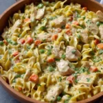 Creamy chicken and noodles served in a bowl with herbs and spices