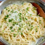 Creamy garlic parmesan pasta served in a bowl with fresh parsley and cheese.