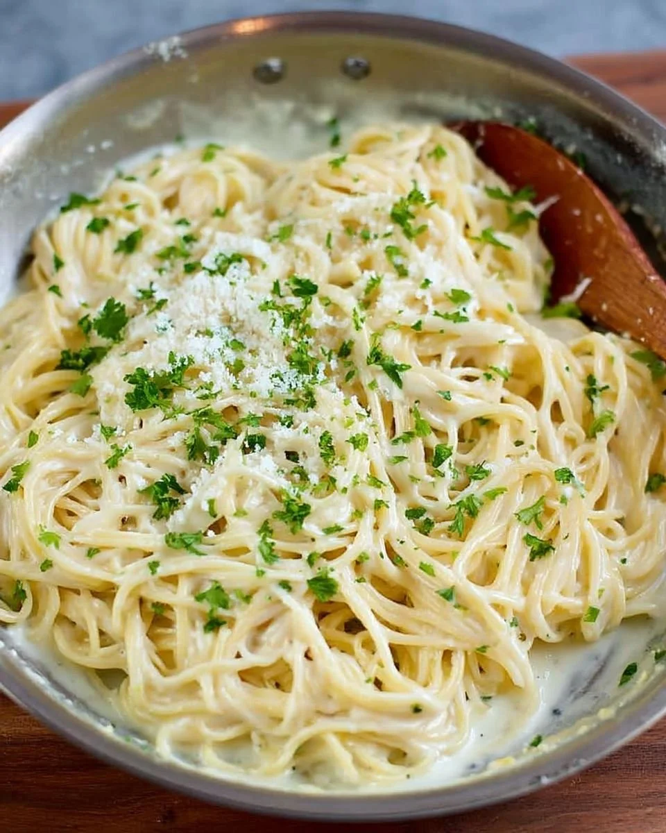 Creamy garlic parmesan pasta served in a bowl with fresh parsley and cheese.