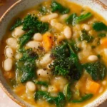 Bowl of flavor-packed white bean soup garnished with herbs