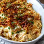 French onion chicken orzo casserole baked in a dish topped with melty cheese