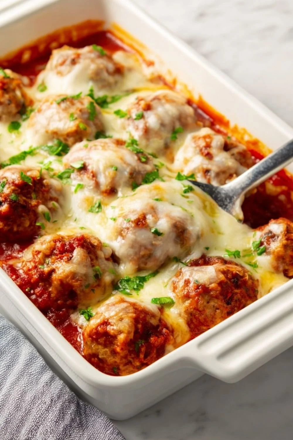 Delicious baked meatballs served with marinara sauce and garnished with parsley
