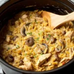 Creamy chicken mushroom orzo in a bowl, garnished with parsley and mushrooms