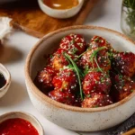 Dish of Korean BBQ meatballs served with spicy mayo dip on a plate