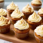 Delicious pumpkin spice cupcakes topped with creamy frosting and autumn spices