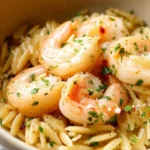 Delicious shrimp scampi orzo served in a bowl with garlic and herbs.