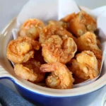 Crispy Southern fried shrimp served with lemon and cocktail sauce