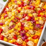 A delicious plate of Hawaiian Sheet Pan Chicken with vibrant vegetables and pineapple.