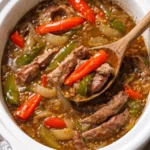 Delicious slow cooker pepper steak served with colorful bell peppers and rice