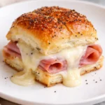 Delicious Cheesy Ham and Cheese Sliders served on a platter.