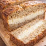 Cream Cheese-Filled Banana Bread loaf with slices on a plate