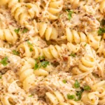 4 Ingredient Crockpot Garlic Parm Chicken with creamy sauce and tender chicken pieces.