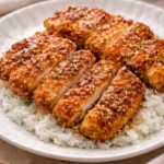 Delicious honey garlic crispy chicken served with a side of vegetables.