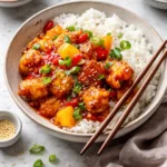 Delicious sweet and sour chicken served with colorful vegetables