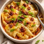 Viral dumpling lasagna showcasing layered dumplings and cheese in a baking dish.