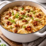 Viral Dumpling Lasagna dish served with cheese and sauce, showcasing comfort food innovation.