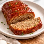 Delicious classic meatloaf served with mashed potatoes and green beans.