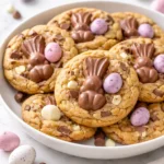A plate of festive Easter Chocolate Cookies decorated with colorful candy eggs.