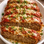 Hearty Italian meatloaf served with herbs and sauce