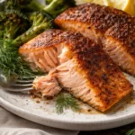 Delicious oven-baked salmon served with fresh herbs and lemon