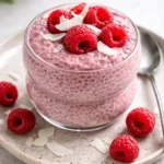 Healthy Raspberry Chia Pudding topped with fresh raspberries and nuts