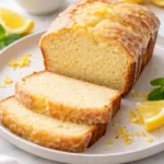 Sourdough Discard Lemon Cake topped with lemon glaze on a white plate