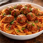 Plate of amazing tender meatballs with marinara sauce and fresh herbs