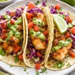 Delicious Baja Fish Tacos with fresh fish and toppings served on a plate