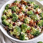 Colorful broccoli salad with fresh vegetables and dressing