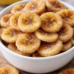 Cinnamon-sugar air fryer banana chips in a bowl