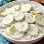 Creamy cucumber salad with fresh ingredients in a bowl