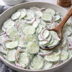Fresh and vibrant cucumber salad served in a bowl with herbs and dressing