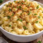 Deviled egg macaroni salad in a serving bowl with garnishes