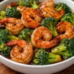 High-protein honey garlic shrimp dish served with green vegetables