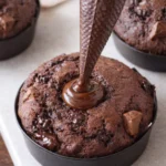 Freshly made Olympic Village Muffins on a wooden table.