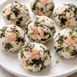 Tasty tuna rice balls served on a plate, sprinkled with sesame seeds