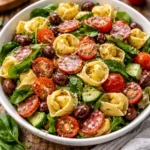 Bowl of colorful Tortellini Pasta Salad with fresh vegetables and dressing