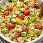 Bowl of Cilantro Lime Pasta Salad with colorful vegetables and cilantro garnish.
