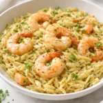 Delicious garlic butter prawn orzo served in a bowl with fresh herbs