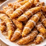 Delicious air fryer apple fries served on a plate with cinnamon sugar