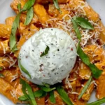 Creamy tomato burrata pasta served in a bowl with fresh herbs