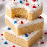 Patriotic sugar cookie bars decorated with red, white, and blue icing