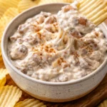 Delicious caramelized onion dip served with crackers for snacking